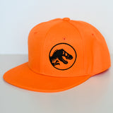 Orange Jurassic Snapback with a black dinosaur logo on a light gray background