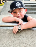 Kids checkered snapback hat with embroidered smiley in white